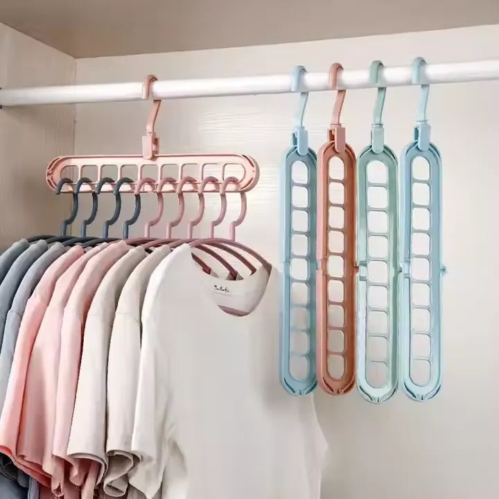 Colorful 9 in 1 Smart Hanger Pro™ organizers hanging multiple T-shirts neatly in a closet, saving space and keeping clothes perfectly arranged.