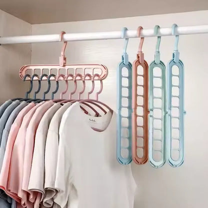 Colorful 9 in 1 Smart Hanger Pro™ organizers hanging multiple T-shirts neatly in a closet, saving space and keeping clothes perfectly arranged.